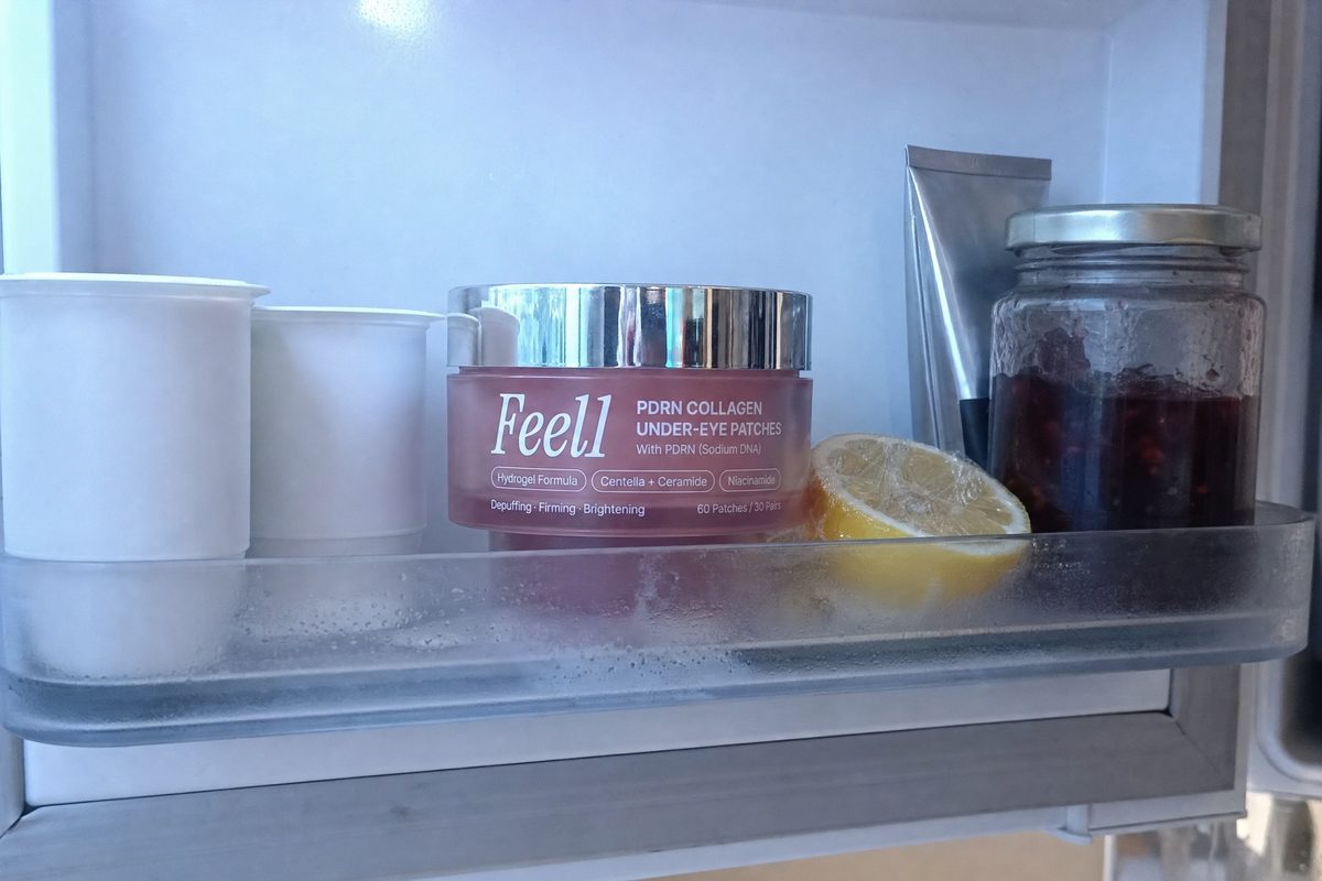 Inside of a fridge door with a frosted jar of Feel1 PDRN under-eye patches standing between yogurt pots